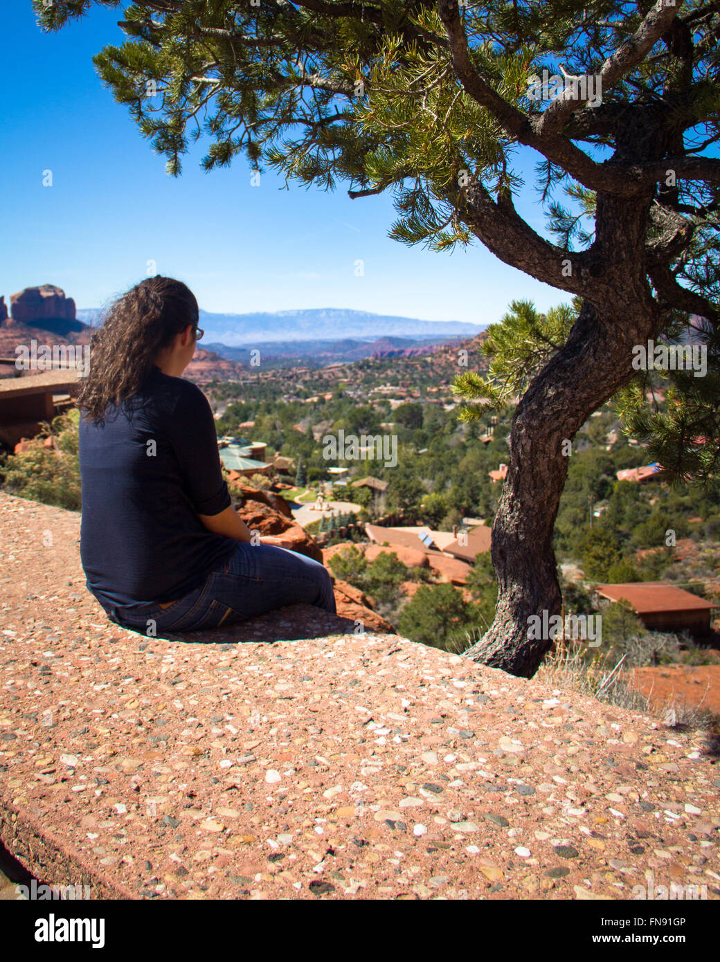Woman sitting on wall, Yuma, Arizona, United States Stock Photo
