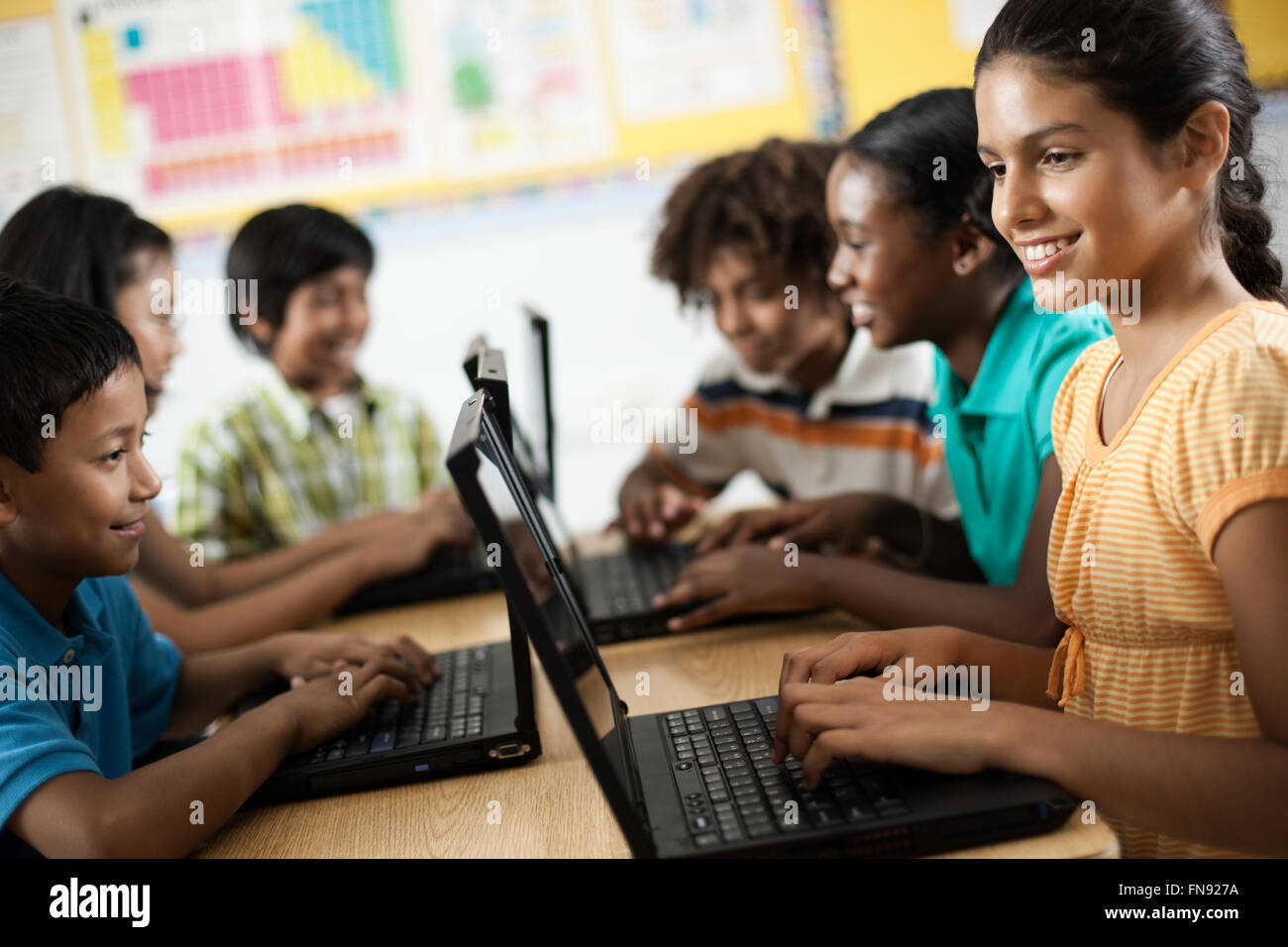 A group of students using laptops in a lesson. Stock Photo