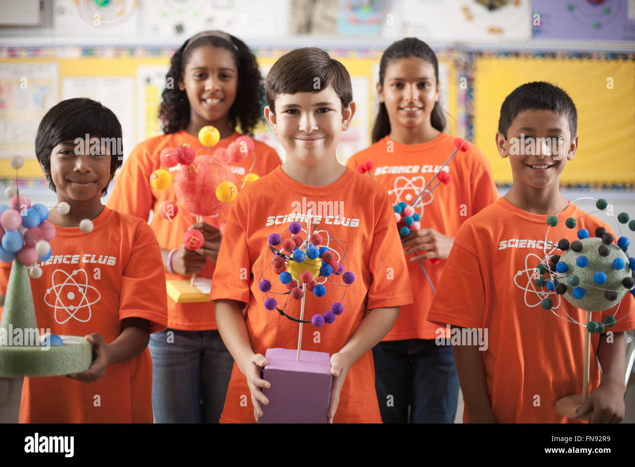 A group of girls and boys wearing the teeshirt of the Science Club, making molecular structure models. Stock Photo