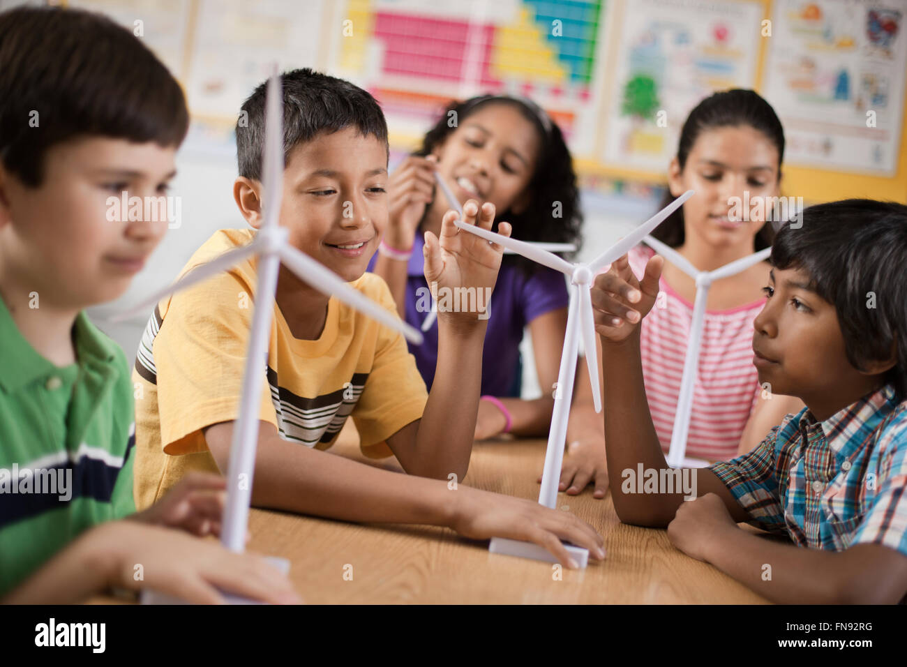 A group of young girls and boys with wind turbine models. Stock Photo