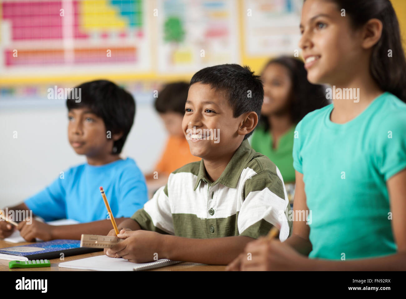 A group of young girls and boys in a classroom, classmates. Stock Photo