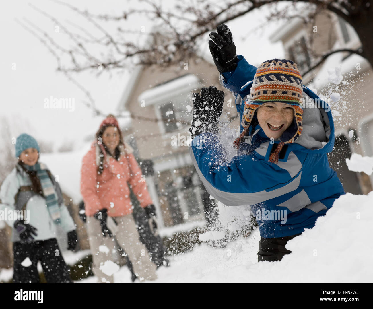 Winter snow. Three children having a snowball fight. Stock Photo