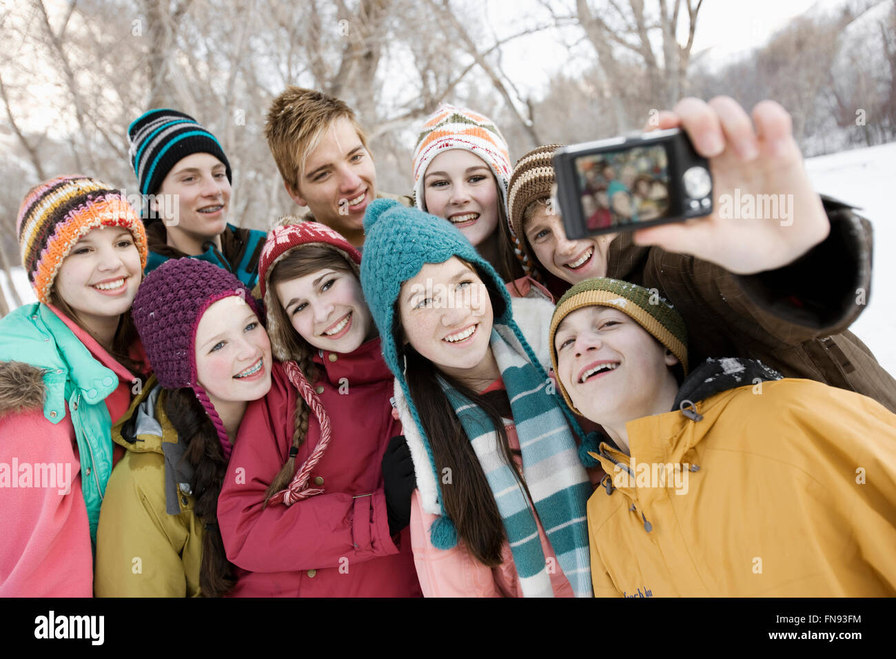 A group of friends posing for a selfy in the snow. Stock Photo