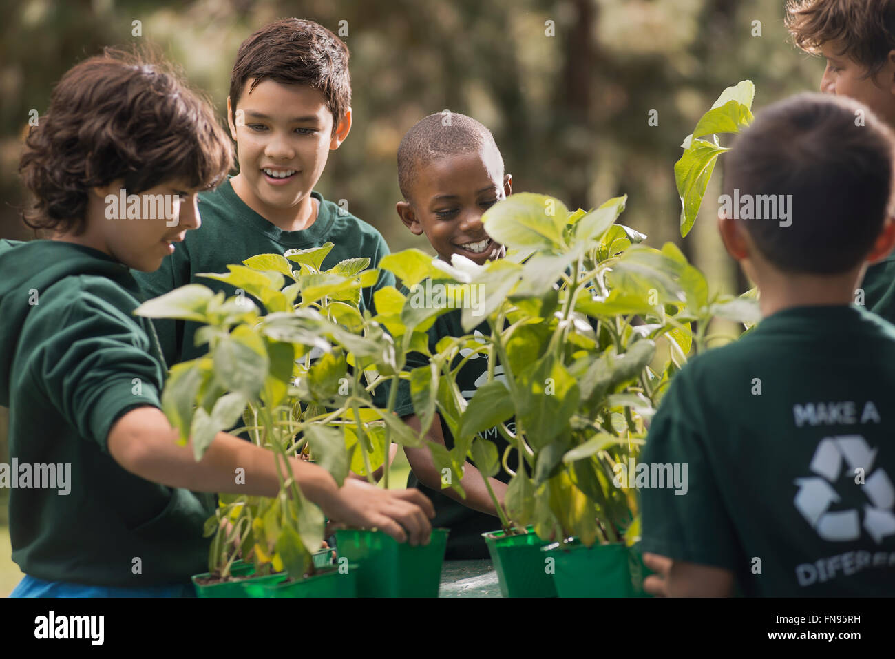 Children in a group learning about plants and flowers, in an afterschool club or summer camp