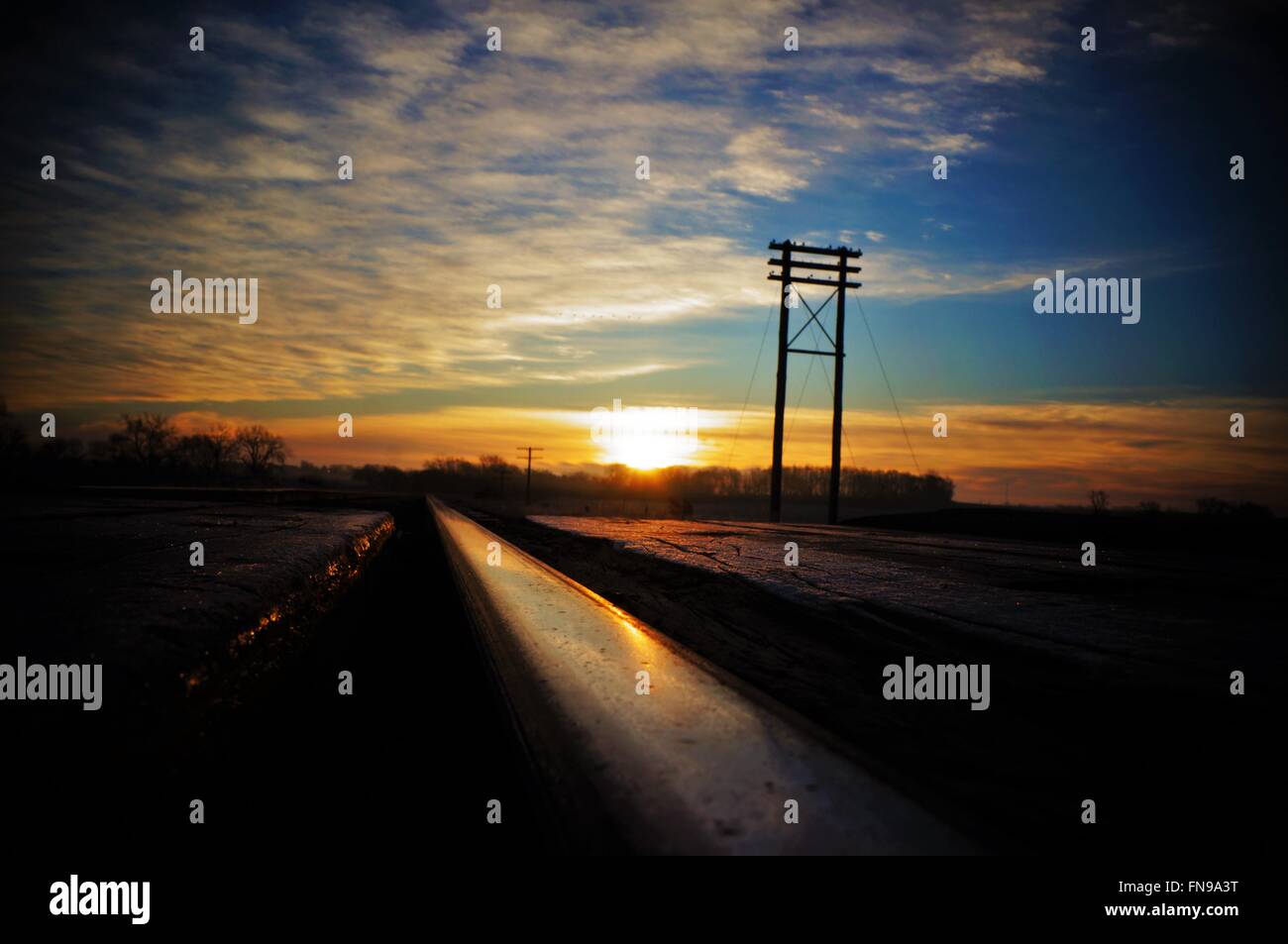 Sunrise with the tracks, warmth of the sun. Johnny Cash would be proud. Stock Photo