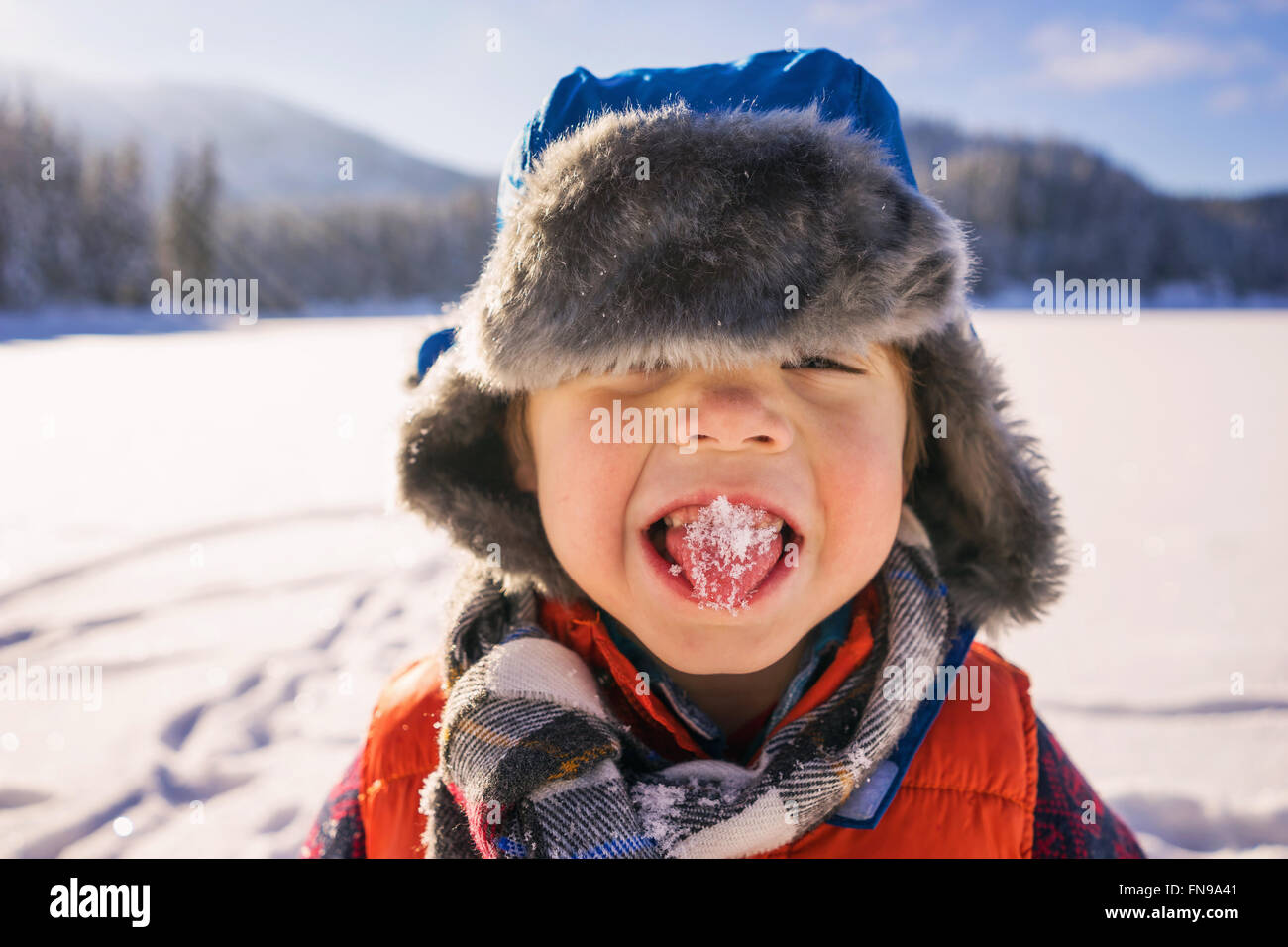 Boy with snow on his tongue Stock Photo