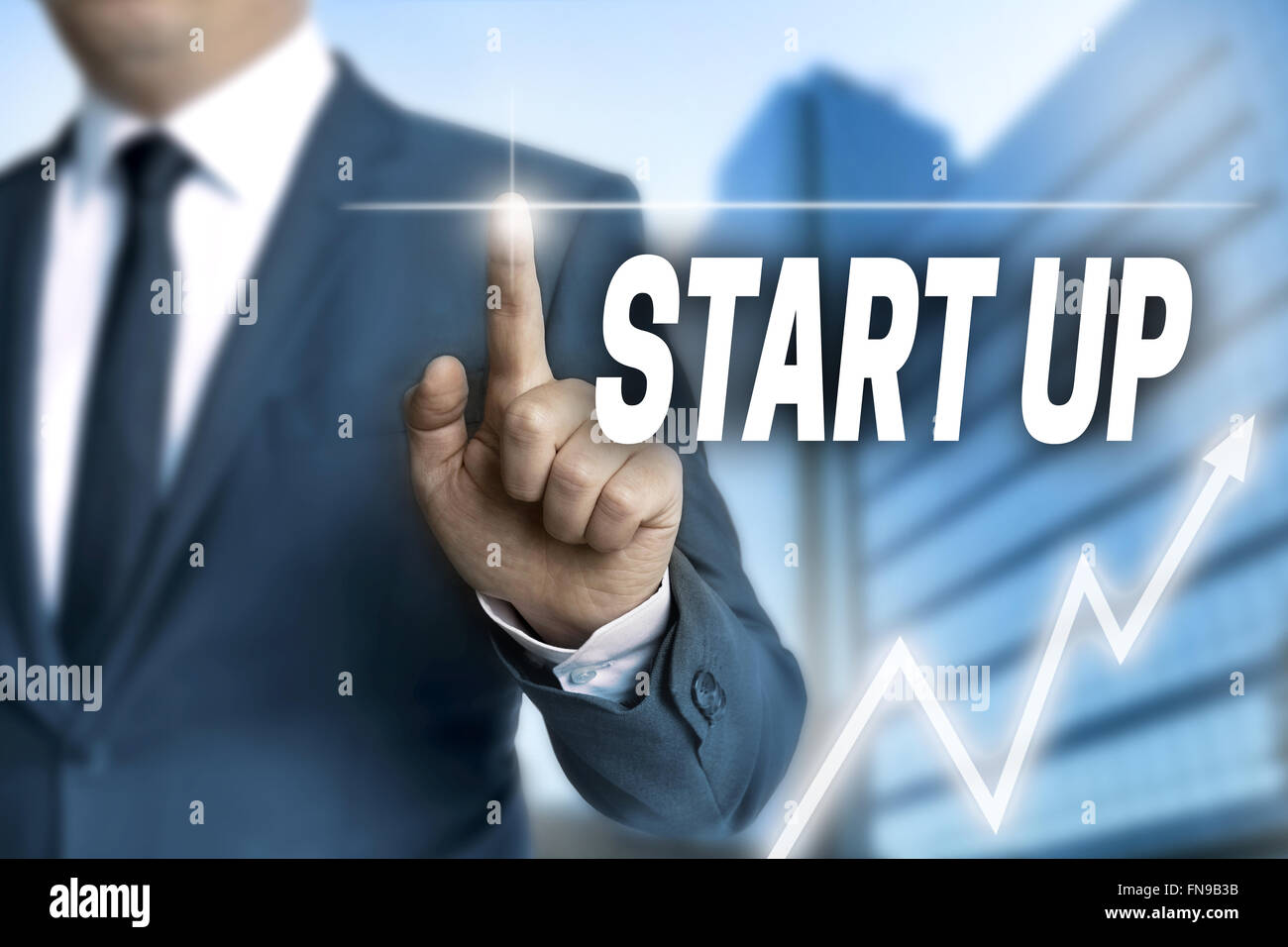 start up touchscreen is operated by businessman. Stock Photo
