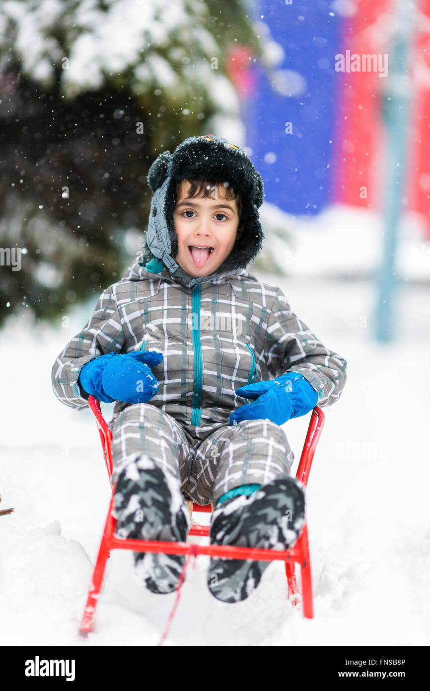 Portrait of a boy catching snowflakes with his tongue Stock Photo