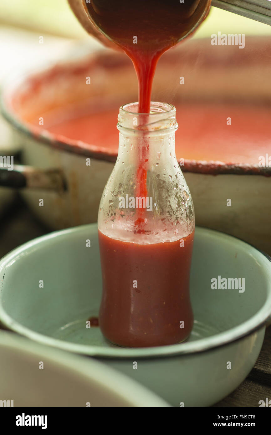 Pouring homemade tomato sauce into a bottle Stock Photo Alamy