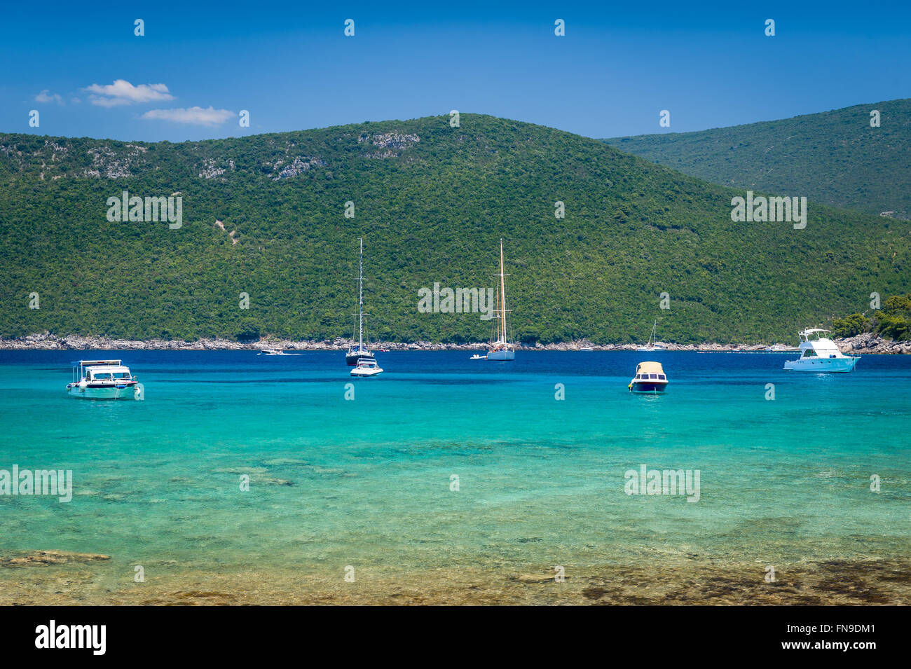 Recreational boats and yachts at anchor in a beautiful calm bay with dreamy water Stock Photo