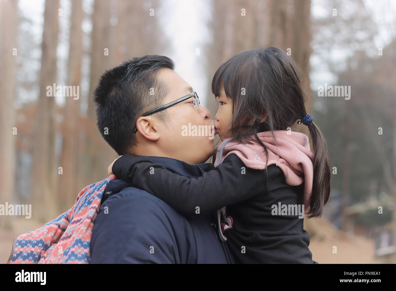 Father kissing his daughter Stock Photo
