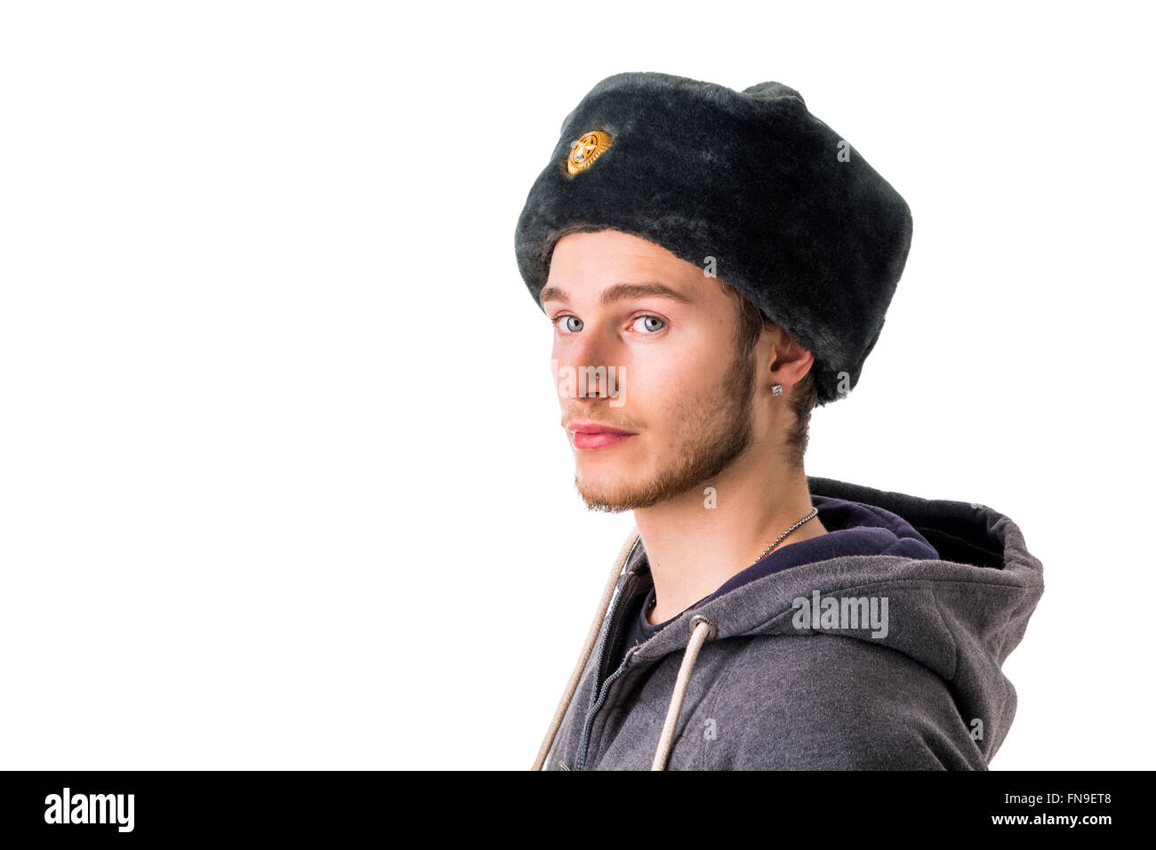 Headshot of handsome blond young man, wearing russian fur hat. Guy has blue eyes, isolated on white Stock Photo