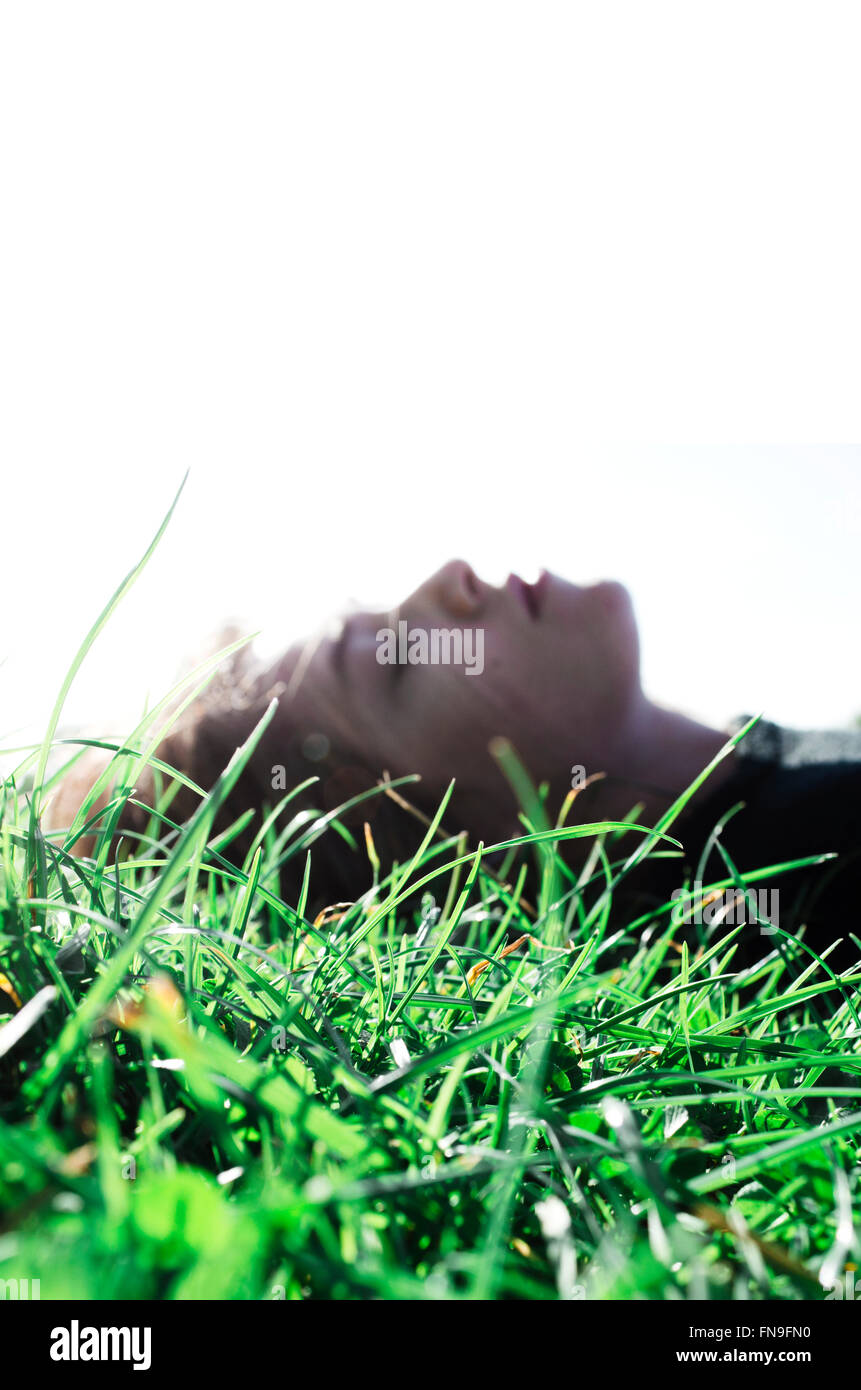 Woman lying on grass Stock Photo