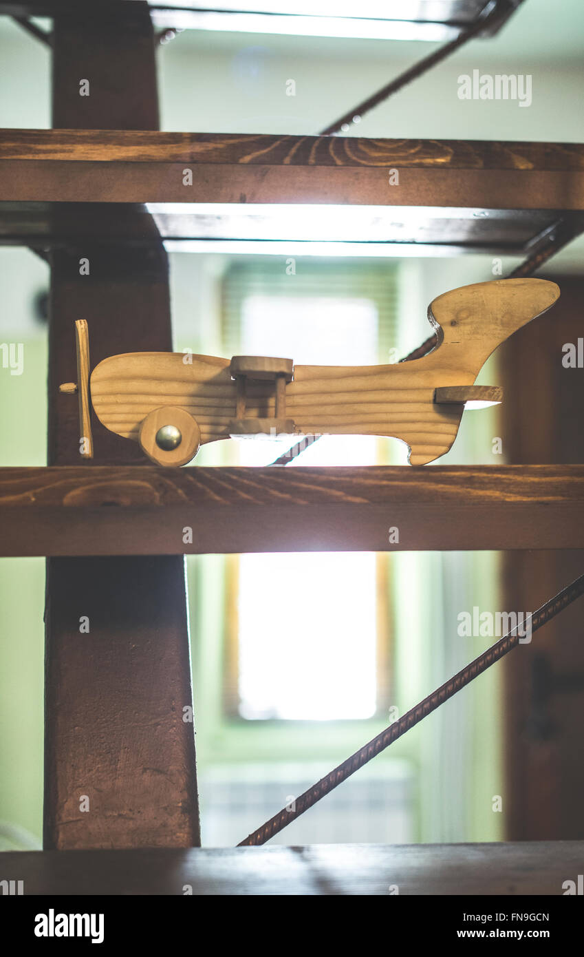 Vintage wooden model plane on shelf Stock Photo
