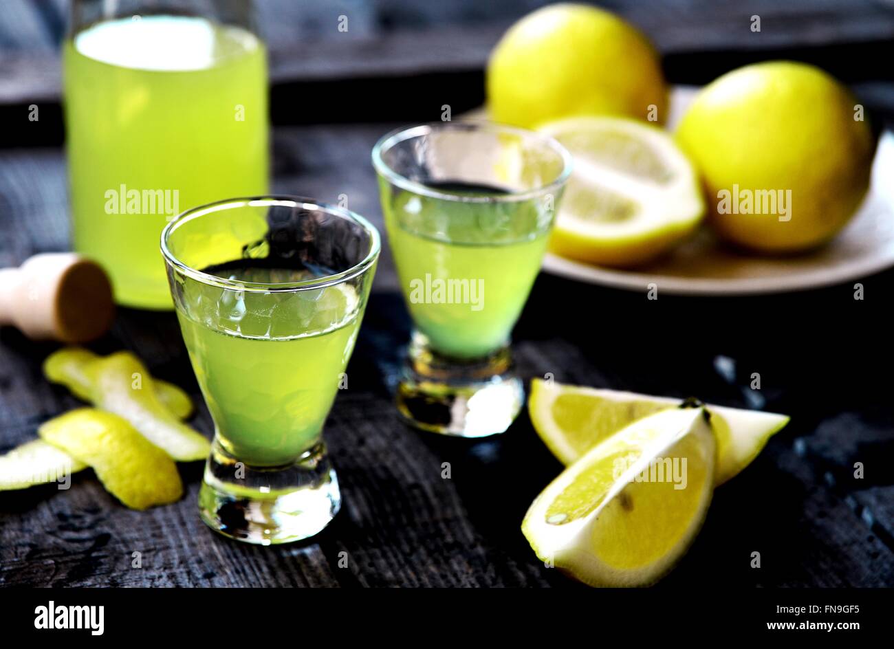Limoncello shots and lemons Stock Photo