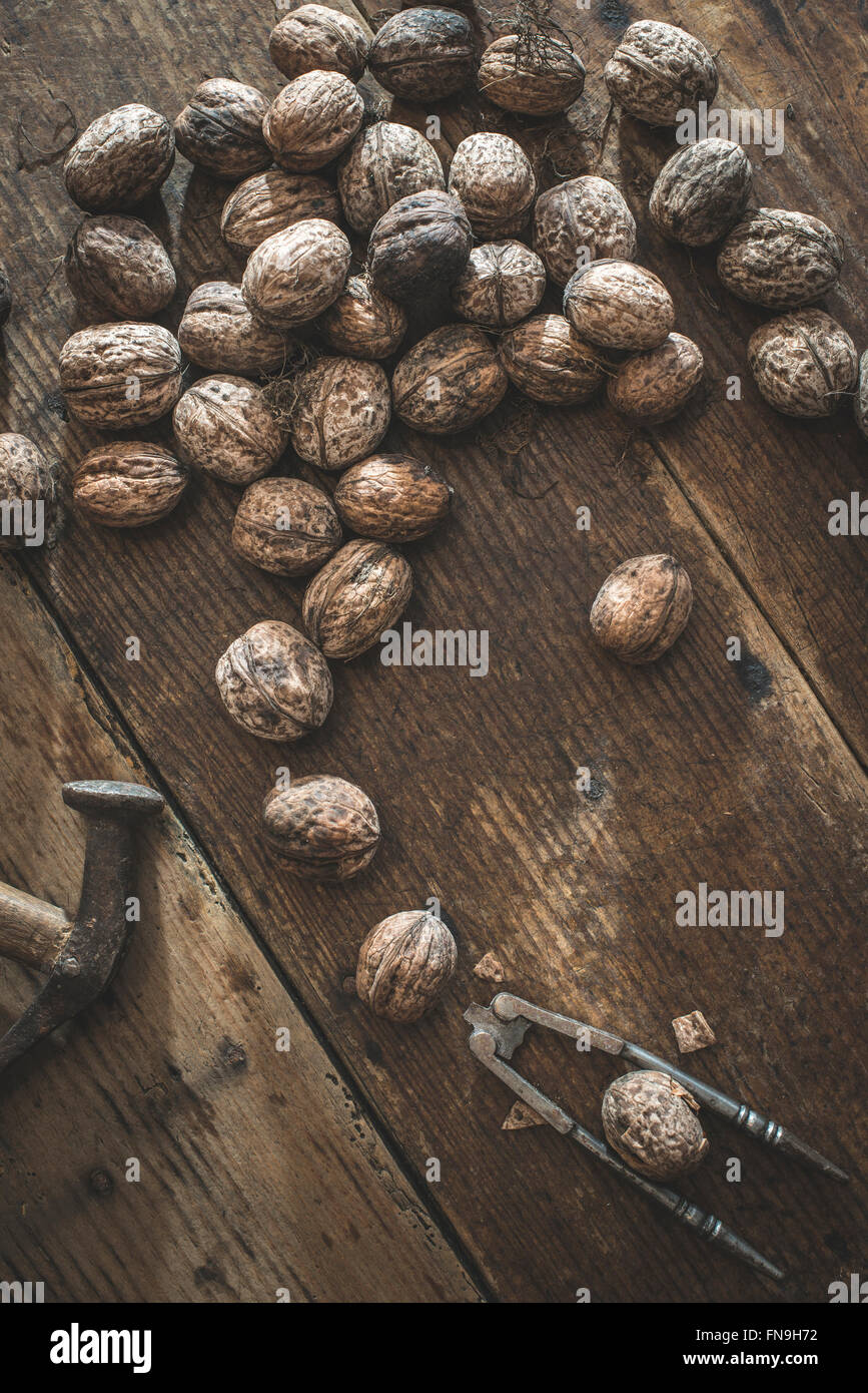 Walnuts, hammer and nutcracker Stock Photo