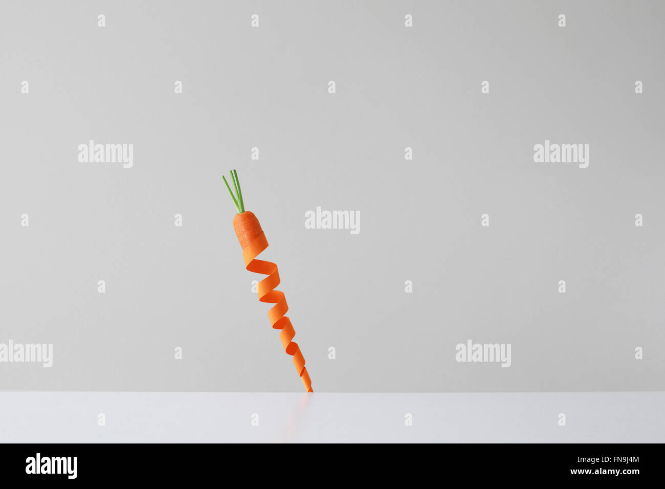 Conceptual carrot made from twisted orange paper Stock Photo