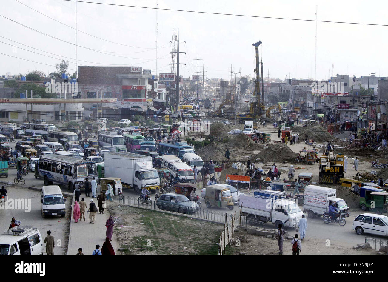 Heavy machineries busy in construction work of Orange Line Metro Train project under the supervision of Provincial Development Department while large numbers of vehicles stuck in traffic jam at Multan road in Lahore on Monday, March 14, 2016. Stock Photo