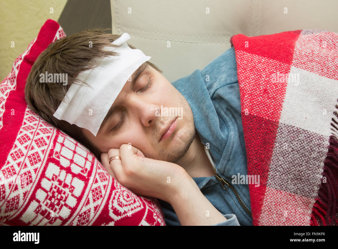 Man with fever sleeping on the sofa Stock Photo Alamy