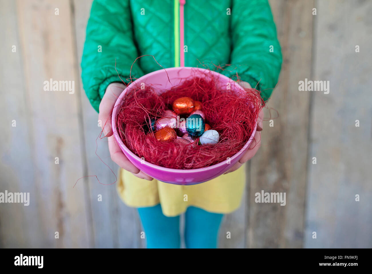 Girl holding bowl of easter eggs Stock Photo