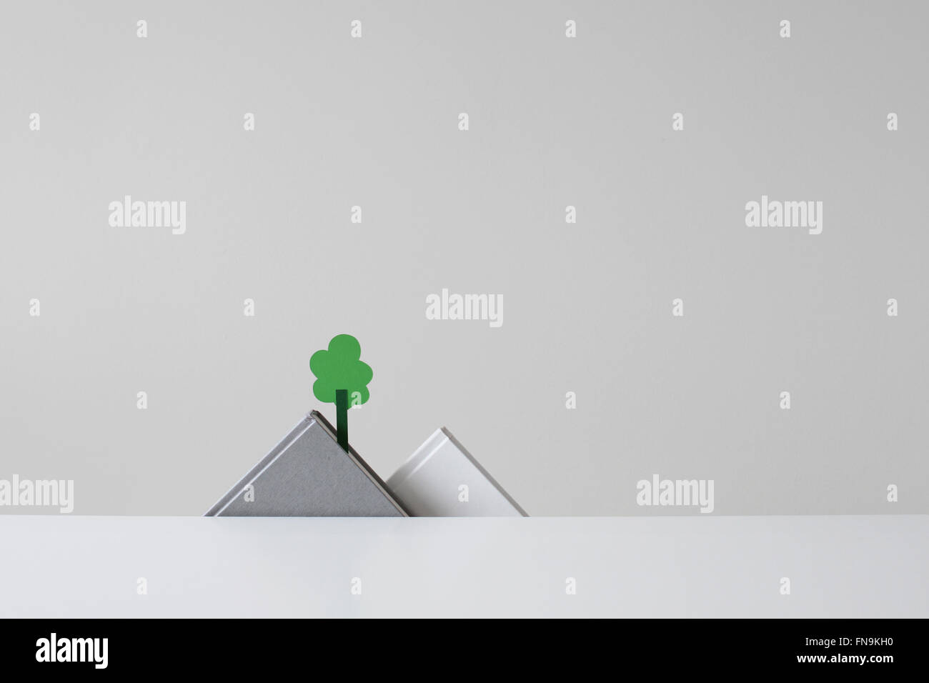 Conceptual Papermade mountain range and tree Stock Photo