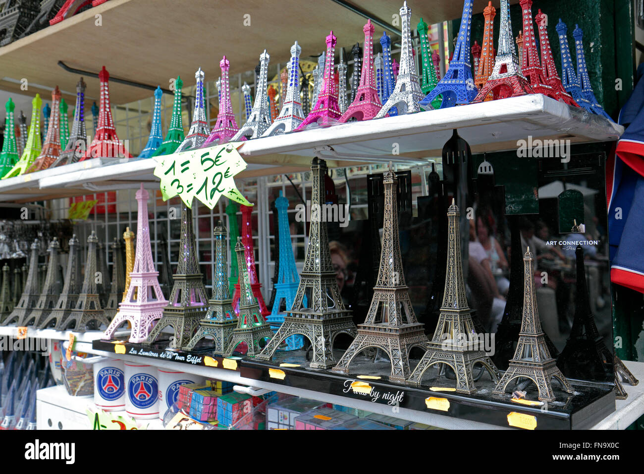 Shelves of miniature Eiffel Tower tourist souvenir gifts in different colours in a shop in Paris, France. Stock Photo