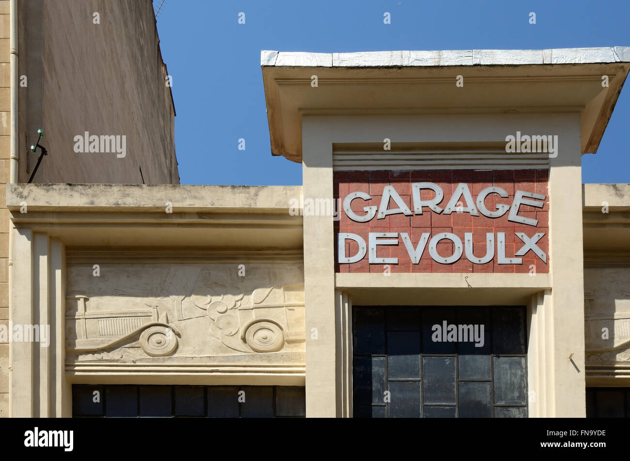 Façade of 1920s Art Deco Garage Devoulx with Bas-Relief or Carving of Vintage Cars Marseille or Marseiles France Stock Photo