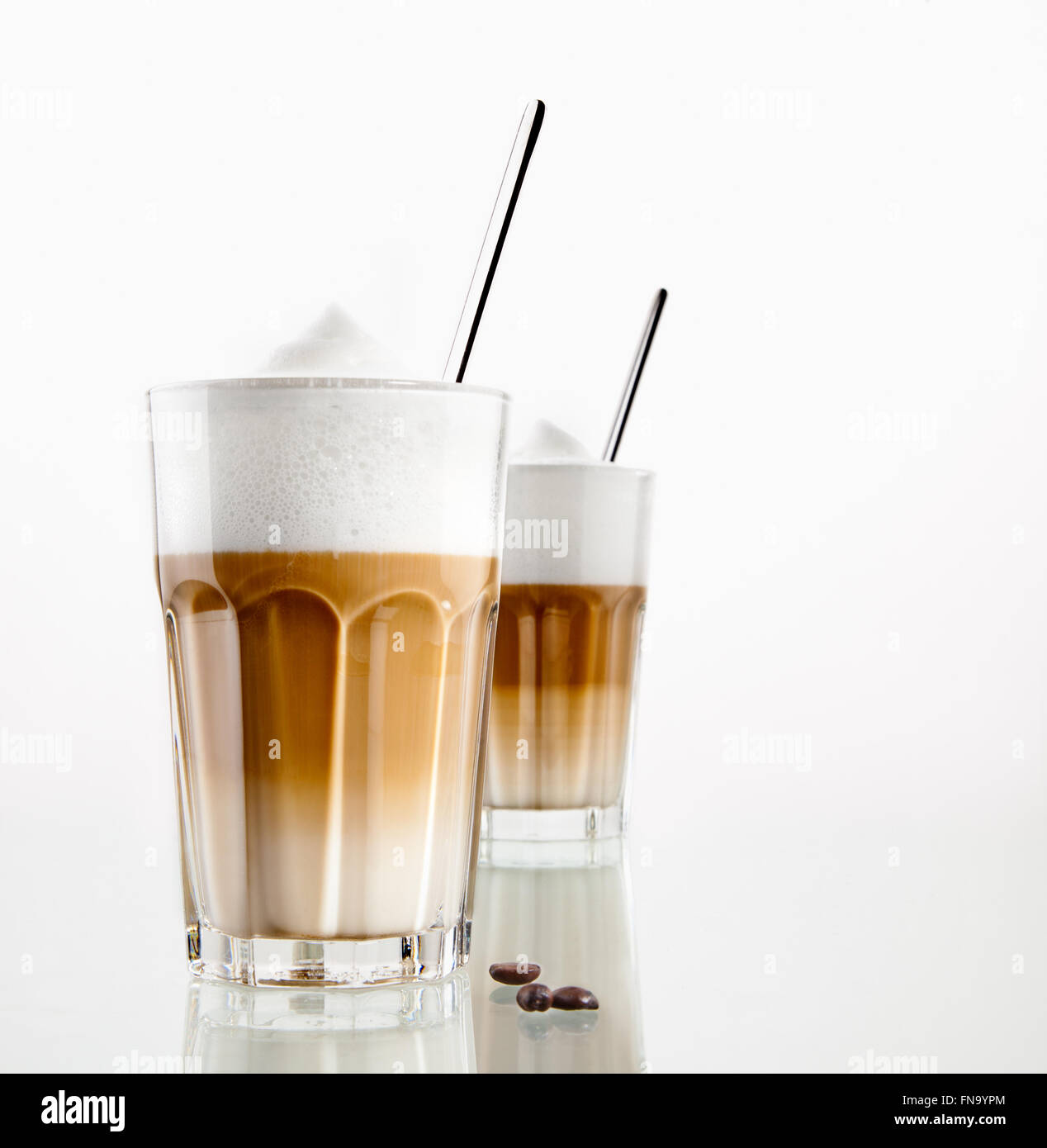 Latte Macchiato coffee in a glass isolated on white Stock Photo