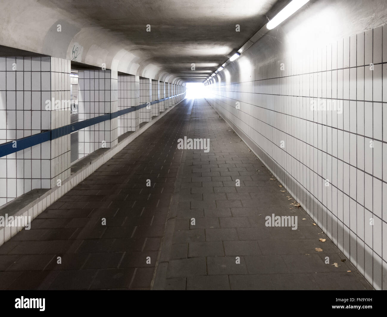 Bright light shining at the end of dark tunnel, urban scene, Netherlands Stock Photo