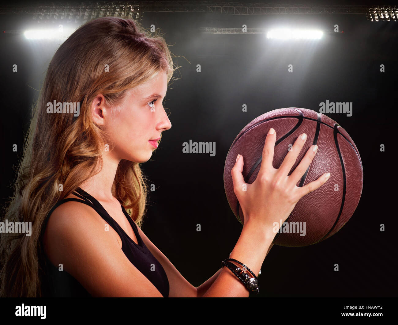 Girl throwing basketball in gym Stock Photo Alamy