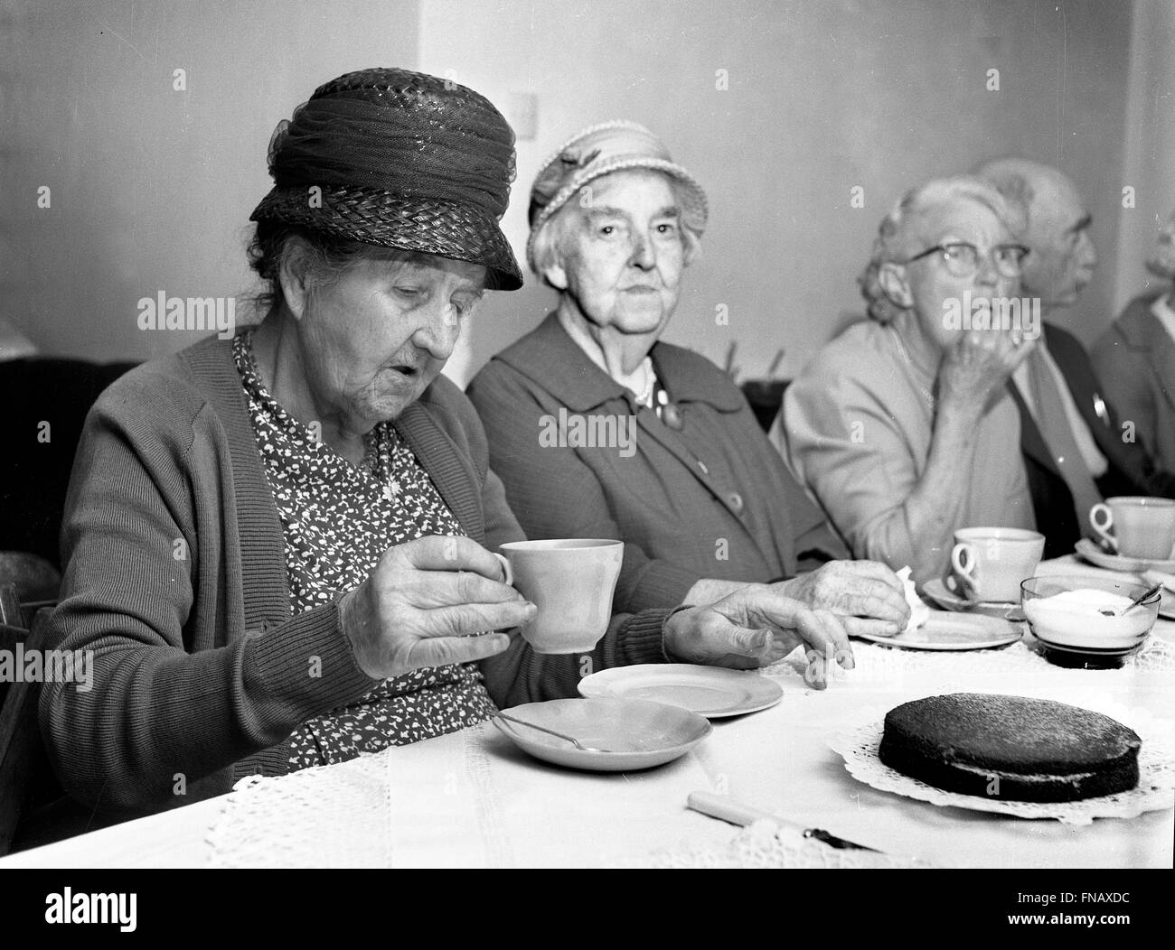 Old elderly folks people socialising over tea and biscuits Britain 1960s PICTURE BY DAVID BAGNALL Stock Photo