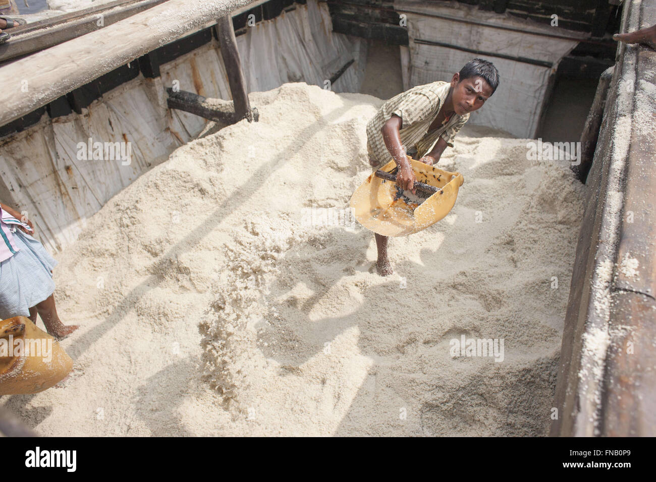 March 12, 2016 - Kutubdia, Bangladesh - A Bangladeshi child labour works in a boat loaded with salt at Kutubdia, around 400 Kilometers away from Dhaka, Bangladesh. (Credit Image: © Suvra Kanti Das via ZUMA Wire) Stock Photo