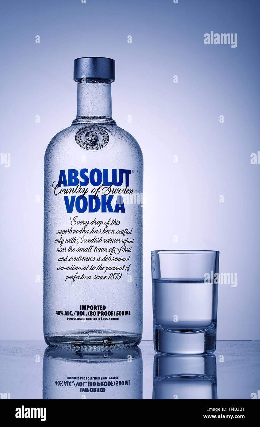 Bottle and a glass of vodka Absolut toned in blue Stock Photo - Alamy