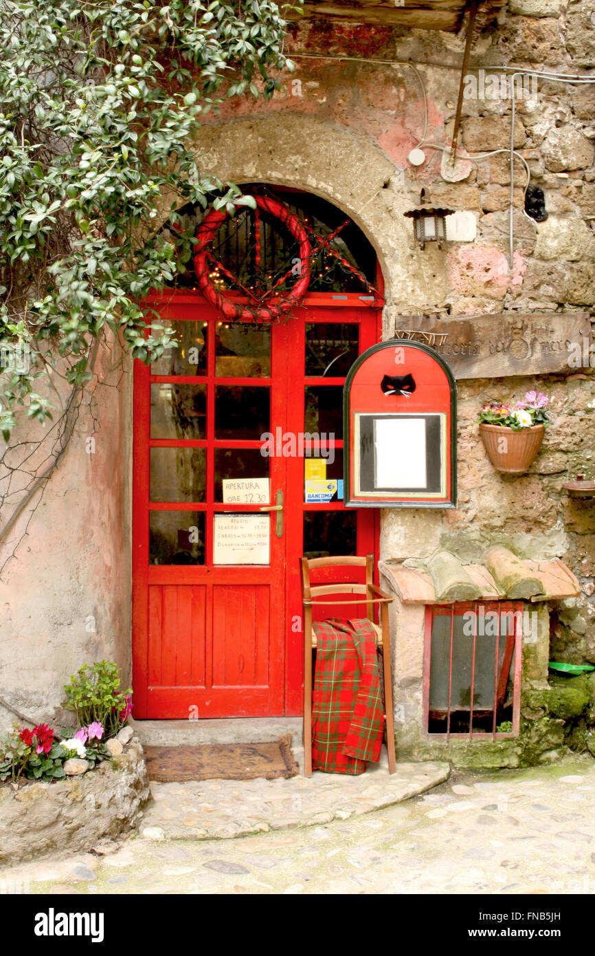Calcata, Italy - February 28, 2010: The black Cat Tavern entry in Calcata. A traditional restaurant built inside an antique medi Stock Photo
