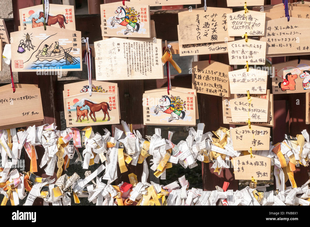 O-mikuji, prayer papers, and Japanese prayer plaques (boards), Ema, Senso-ji, Buddhist temple, Asakusa, Tokyo, Japan Stock Photo