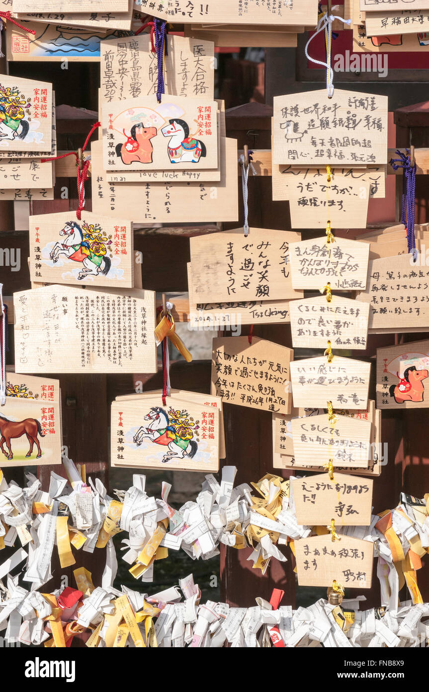 O-mikuji, prayer papers, and Japanese prayer plaques (boards), Ema, Senso-ji, Buddhist temple, Asakusa, Tokyo, Japan Stock Photo