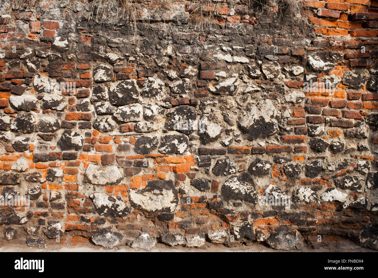 Medieval, old brick and stone wall historic background Stock Photo