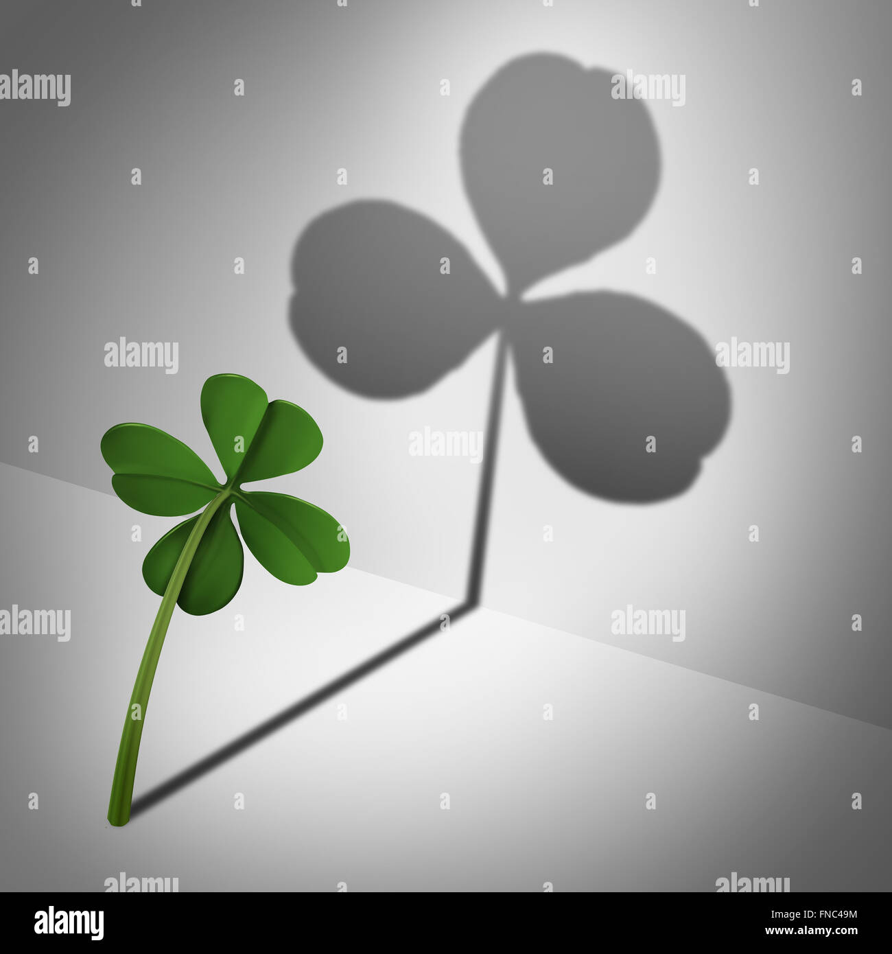 Low self esteem psychological concept as a four leaf clover casting a shadow with only three leaves as a mental health condition of feeling inadequate or negative thinking and low self confidence. Stock Photo