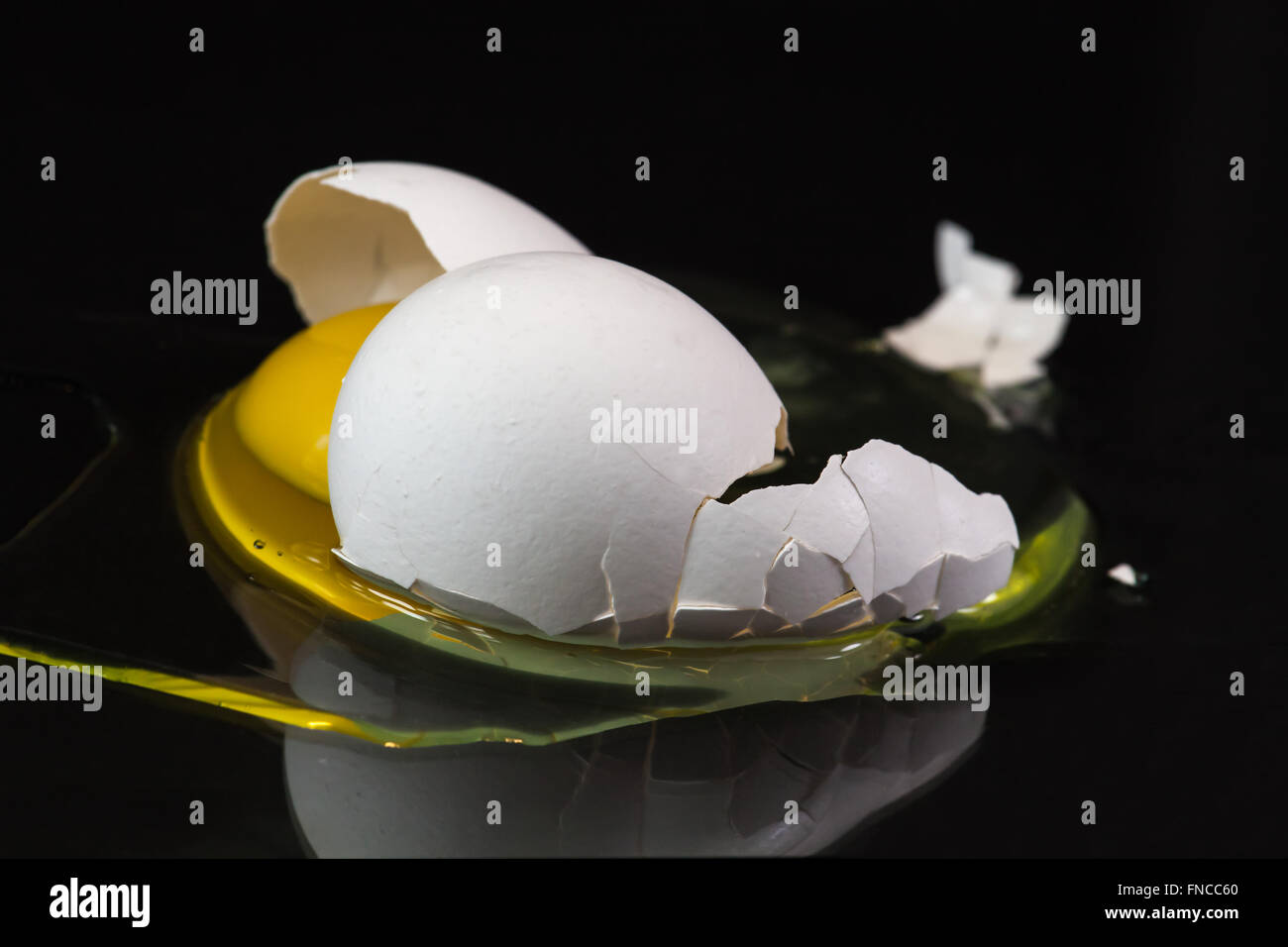 broken organic white egg on black background Stock Photo - Alamy