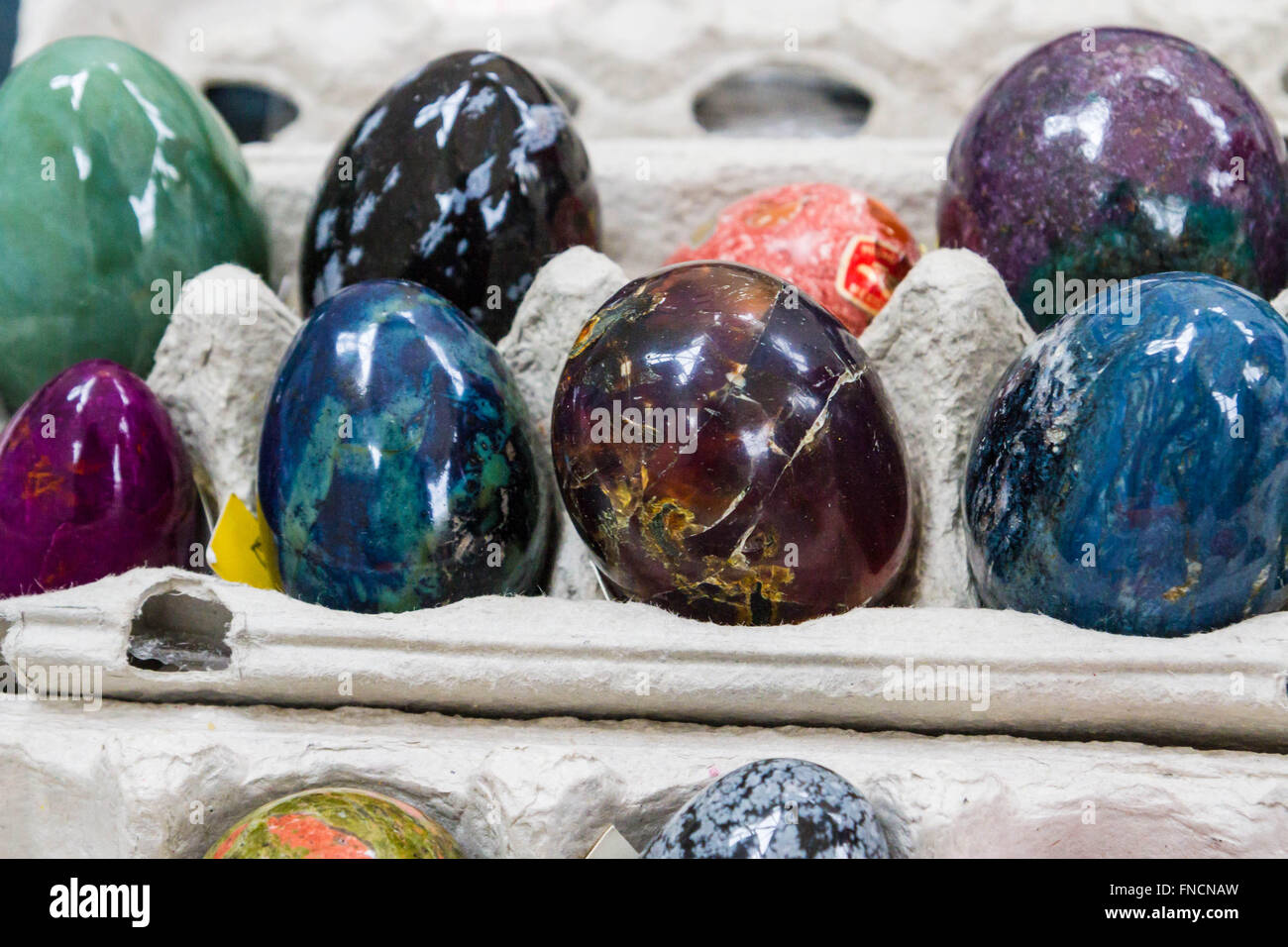 Multicolored marble eggs of stone in cells Stock Photo Alamy