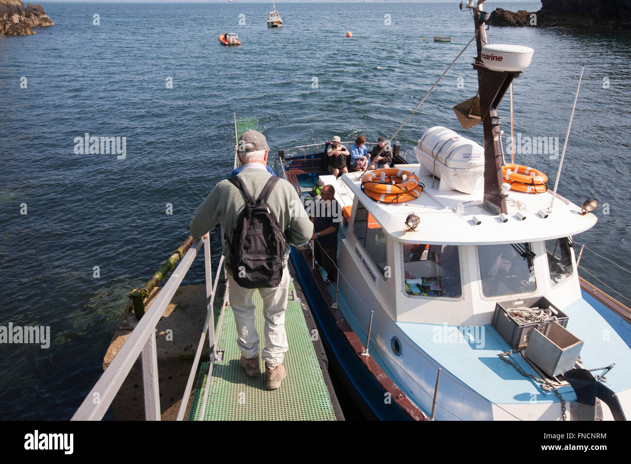 Boarding boat at Martin's Haven to cross short stretch of water to see ...