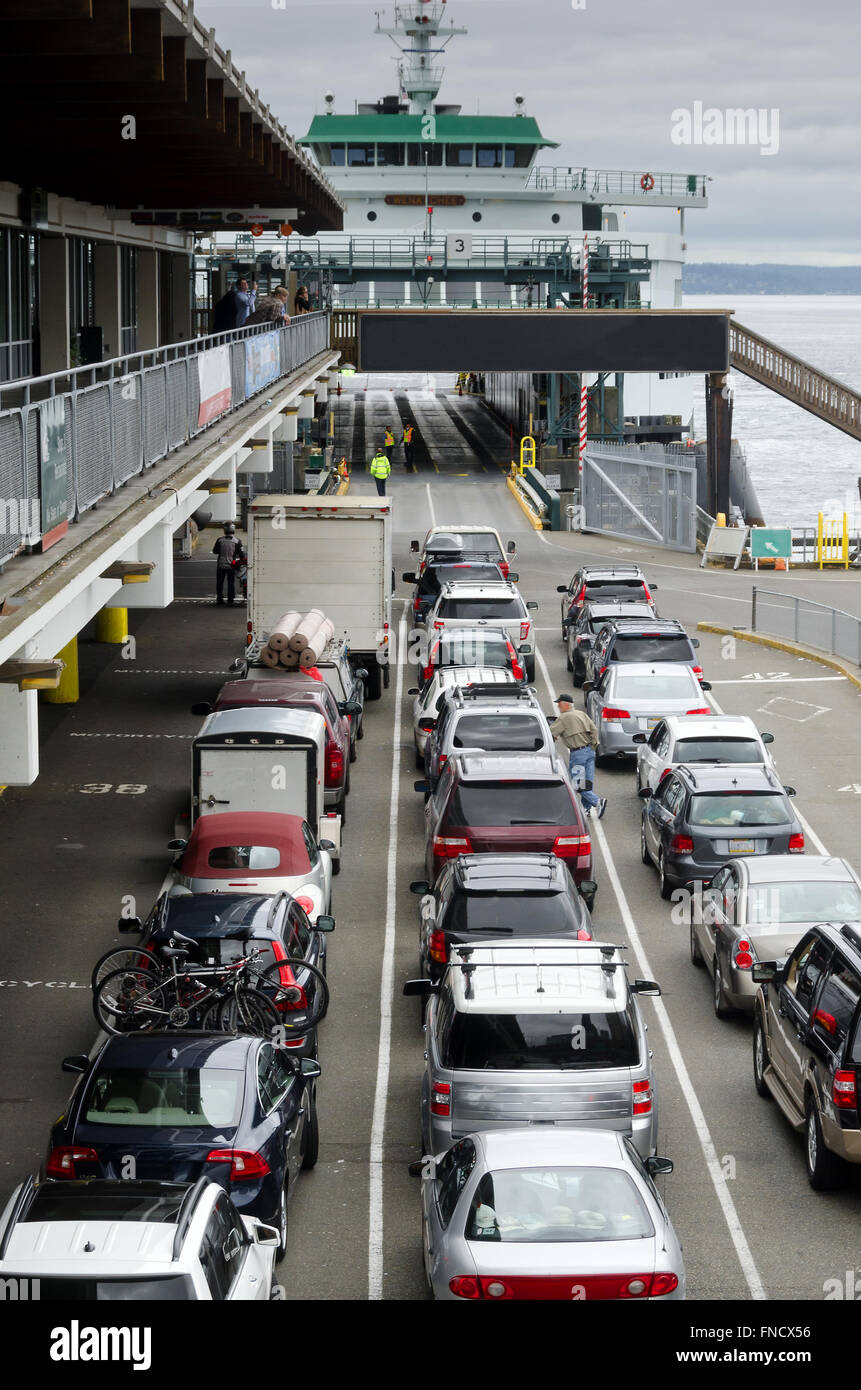 A line of cars waits patiently in order to board a ferry in Washington State’s Puget Sound in Seattle Stock Photo