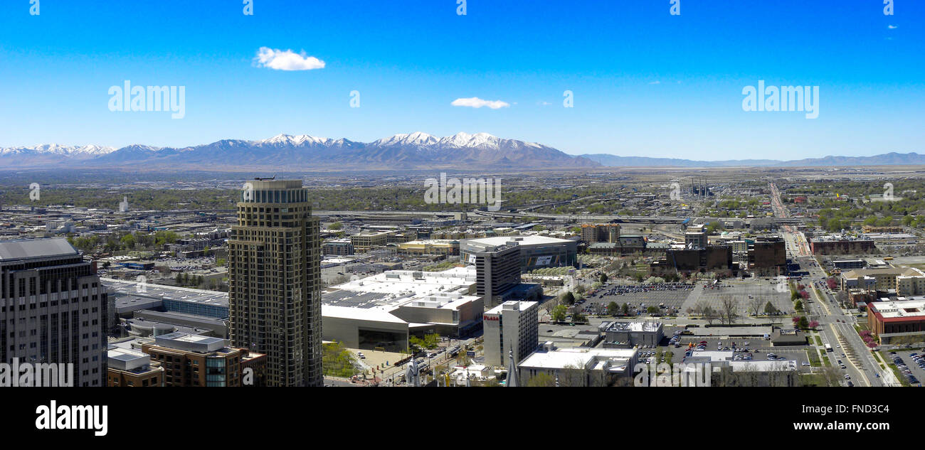 Looking West from LSD conference out over Sal Lake City, long running streets, tall buildings snow capped mountains. Stock Photo