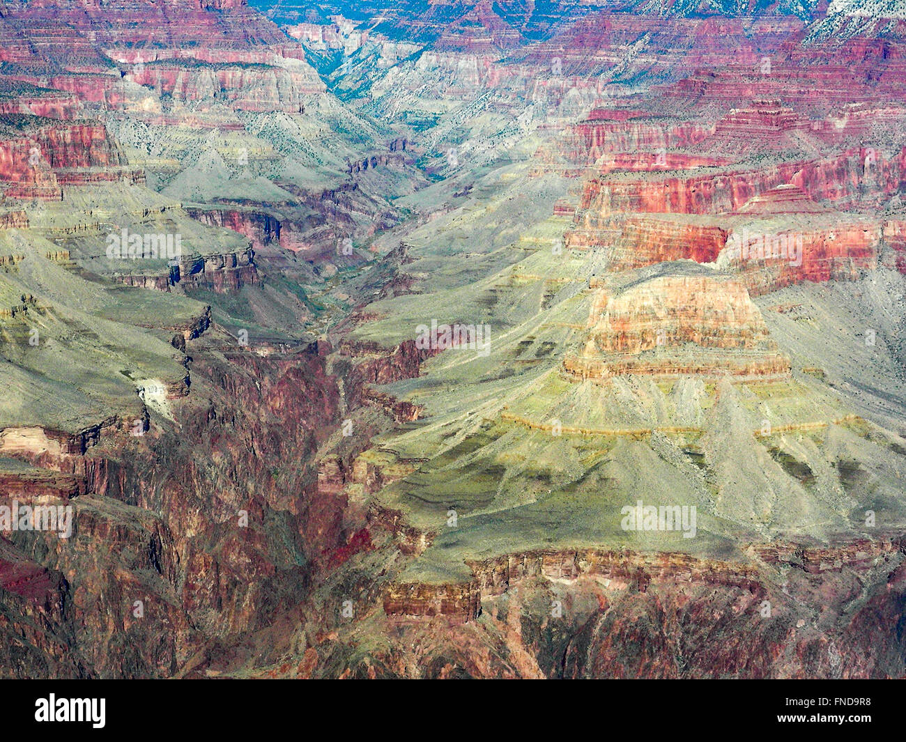 Aerial view of the Grand Canyon, colorful mountains with gorge cutting through the middle. Stock Photo