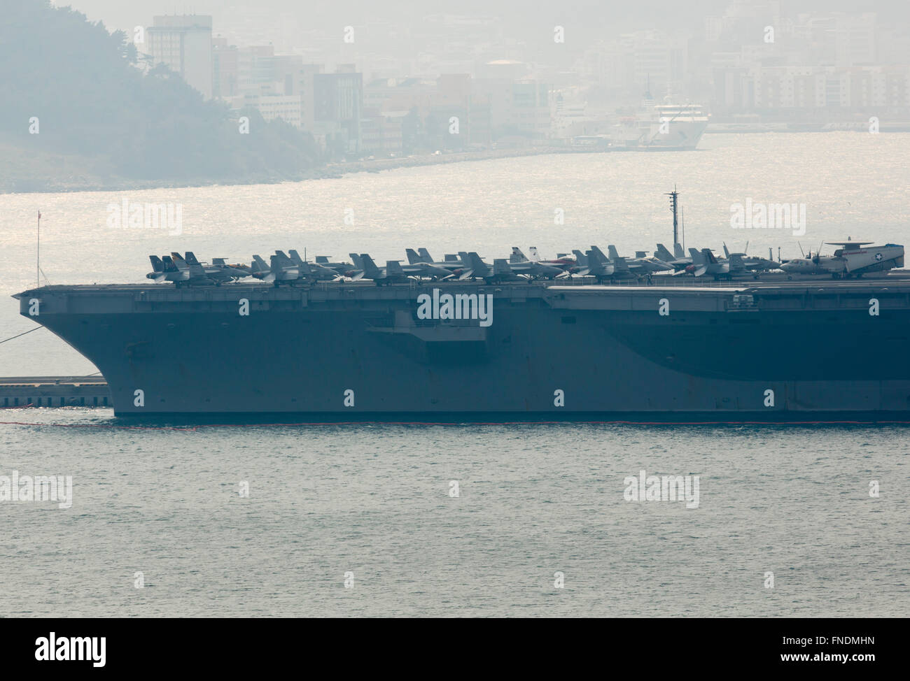 The USS John C. Stennis, Mar 14, 2016 : U.S. nuclear-powered supercarrier, the USS John C. Stennis is seen at a South Korean navy port in Busan, about 450 km southeast of Seoul, South Korea. The USS John C. Stennis (CVN-74) arrived in South Korea on March 13, 2016 to participate in the Key Resolve military drills between South Korea and the United States, which is held from March 7-18. The USS John C. Stennis is the U.S. Navy's seventh Nimitz-class supercarrier, loaded with marine and navy aircraft including the F/A-18 Hornet, EA-6B Prowler combat jets and the E-2C Hawkeye early-warning aircra Stock Photo