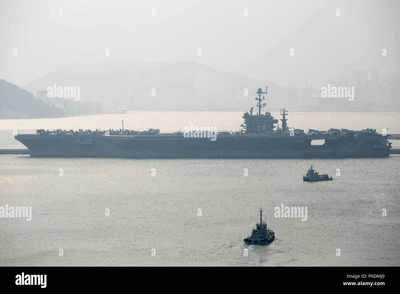 The USS John C. Stennis, Mar 14, 2016 : U.S. nuclear-powered supercarrier, the USS John C. Stennis is seen at a South Korean navy port in Busan, about 450 km southeast of Seoul, South Korea. The USS John C. Stennis (CVN-74) arrived in South Korea on March 13, 2016 to participate in the Key Resolve military drills between South Korea and the United States, which is held from March 7-18. The USS John C. Stennis is the U.S. Navy's seventh Nimitz-class supercarrier, loaded with marine and navy aircraft including the F/A-18 Hornet, EA-6B Prowler combat jets and the E-2C Hawkeye early-warning aircra Stock Photo