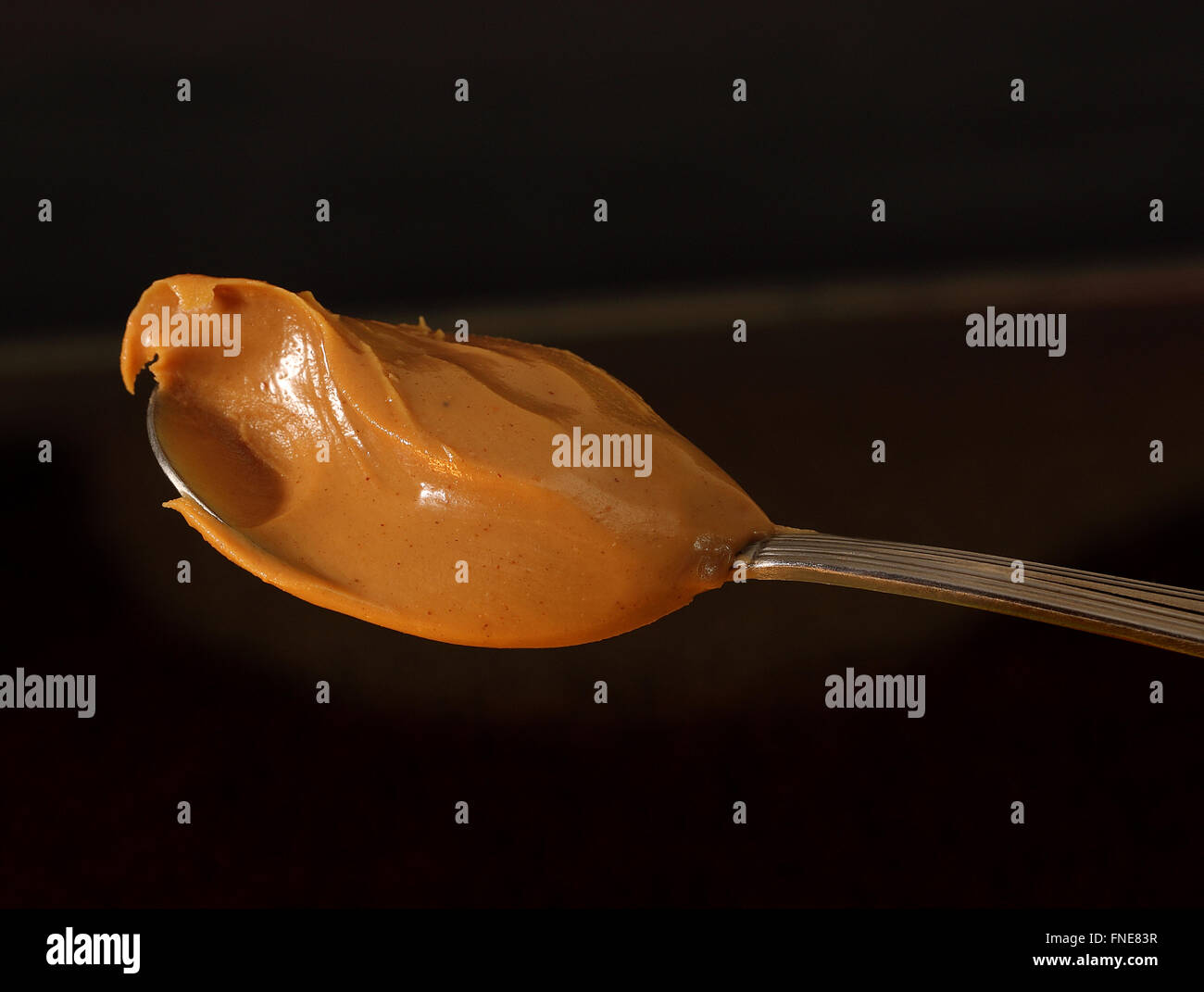 Spoon of peanut butter Stock Photo - Alamy