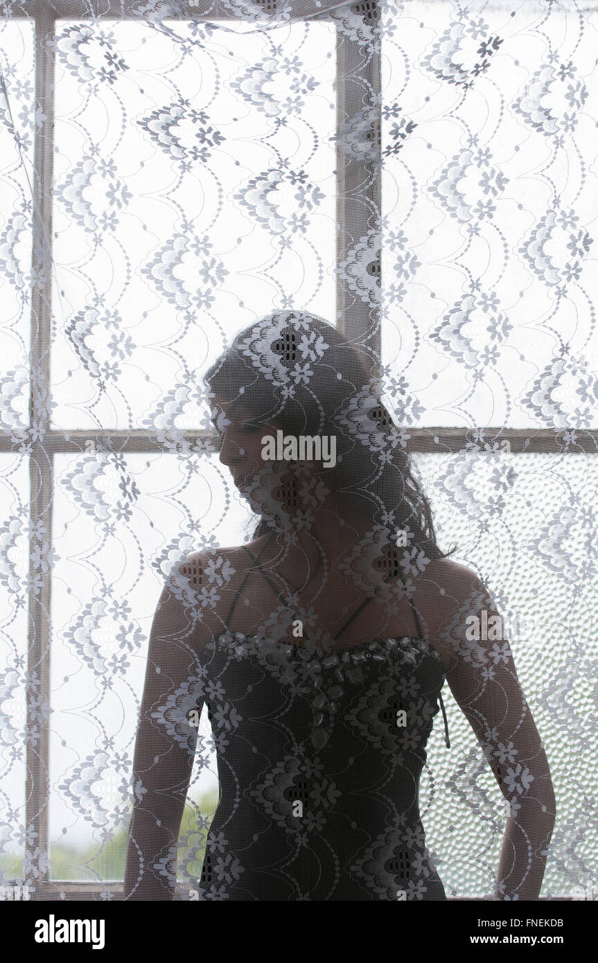 Unhappy Indian woman by the window Stock Photo
