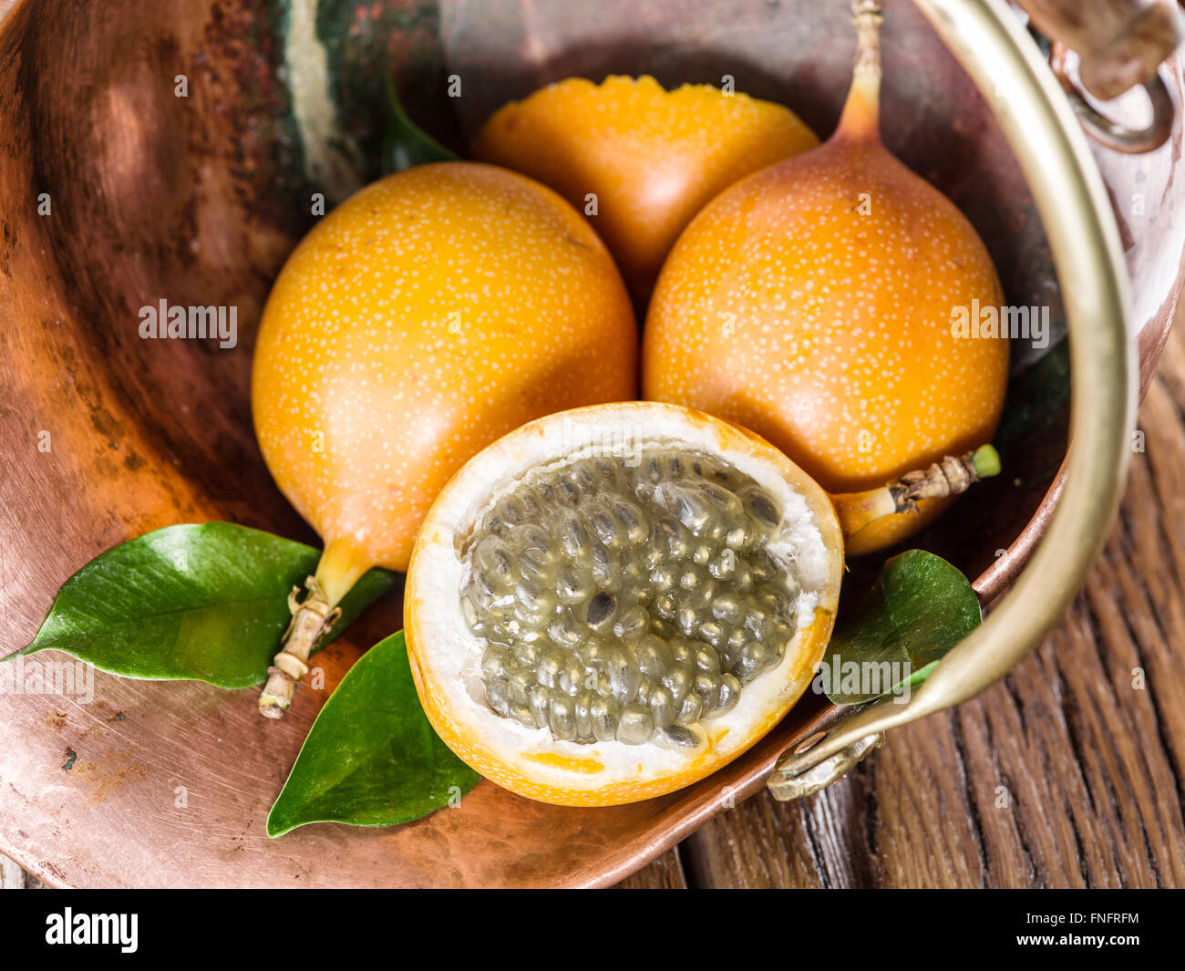 Granadilla fruits in the bruzen bucket Stock Photo - Alamy