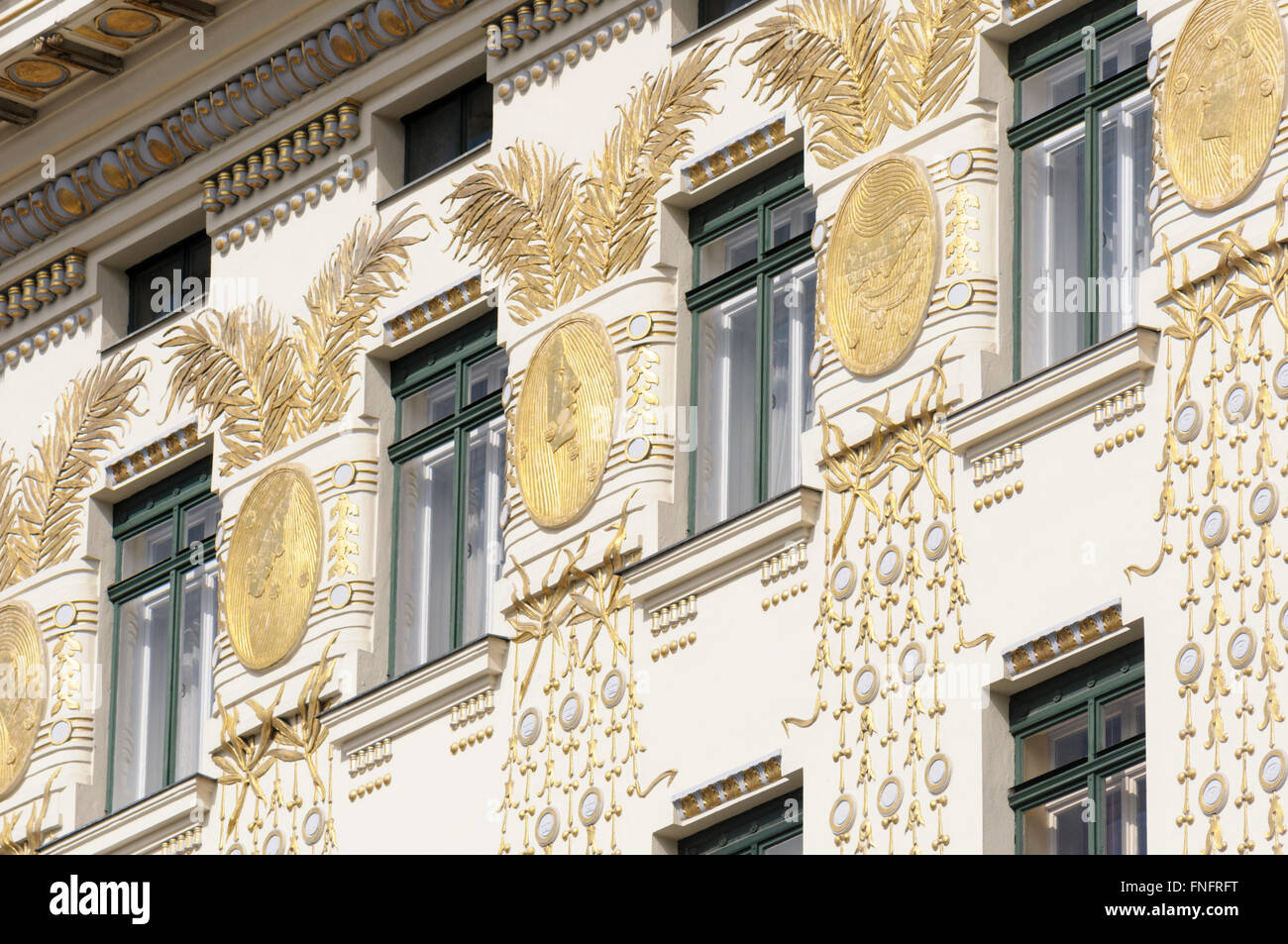 Gilded palm leaves, stylised peacock feathers, coupled together by gold medallions (Kolo Moser) on the facade of the 'Jugendstil Stock Photo